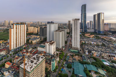 High angle view of buildings in city against sky during sunset