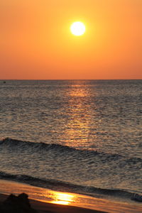 Scenic view of sea against orange sky