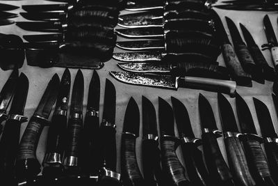 High angle view of various knives on table at market stall