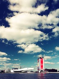 Buildings against cloudy sky