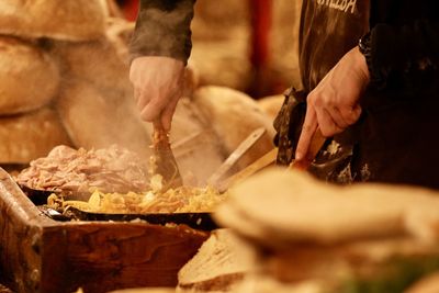 Midsection of person preparing food at market