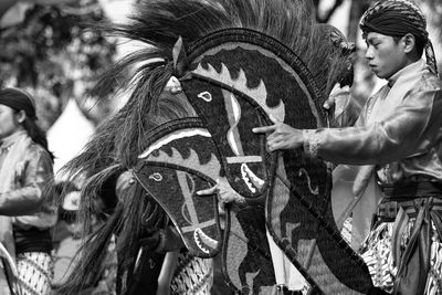 Side view of mid adult man with artificial horse