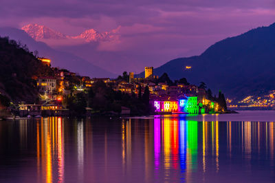 The town of santa maria rezzonico, on lake como, in the evening, with its tower and the snowy alps.