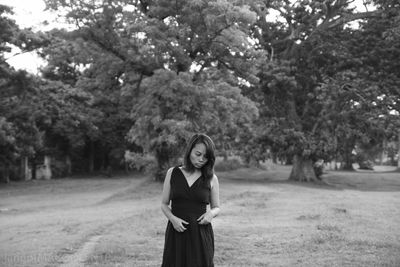 Woman standing on tree trunk