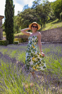 Portrait of woman standing on field