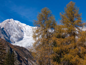 Scenic view of mountains against blue sky