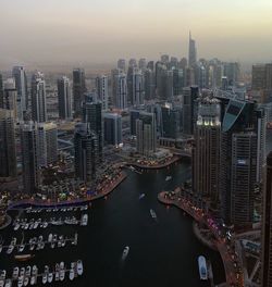 High angle view of city lit up at sunset