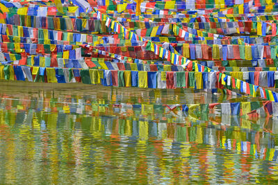 Multi colored umbrellas hanging over lake