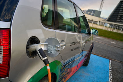 Pamplona, navarra spain 24 april 2021. electric car in charge connected to electric point in cener.