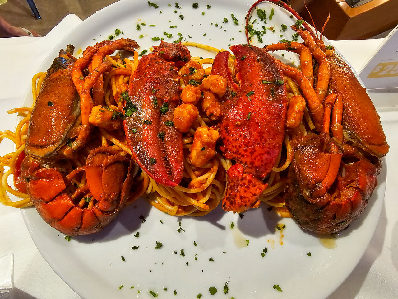 food, food and drink, seafood, plate, crustacean, freshness, healthy eating, animal, meal, seafood boil, table, no people, wellbeing, high angle view, dish, restaurant, indoors, lobster, dinner, close-up, serving size, gourmet, cooked, crab, shrimp