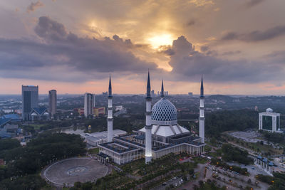 High angle view of buildings against cloudy sky