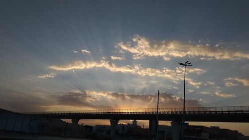 Low angle view of bridge against sky during sunset