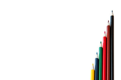 Close-up of colored pencils against white background