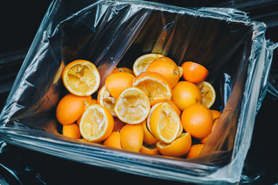 High angle view of orange peels in garbage bin