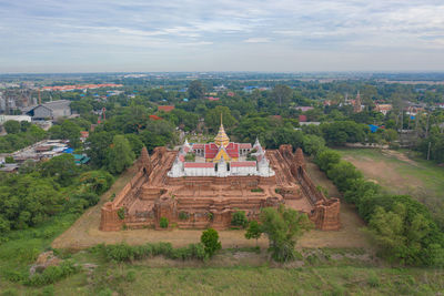 Panoramic view of temple against buildings