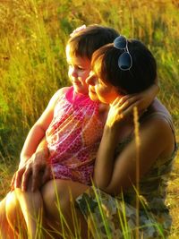 Rear view of woman sitting on grass