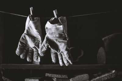 Low angle view of gloves drying on clothesline