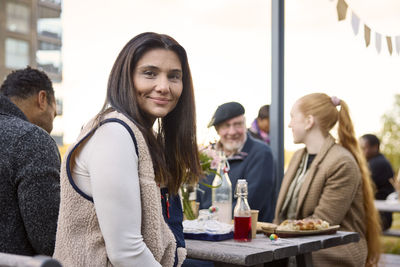 Woman at table looking at camera