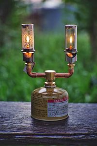 Close-up of illuminated lamp on table