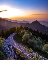 High angle view of road by mountains against sky