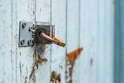 Close-up of rusty padlock on door