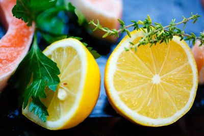 Close-up of lemon slices with herbs on table