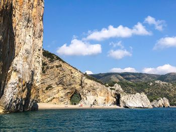 Scenic view of sea and mountains against sky