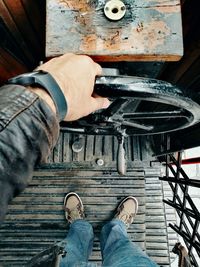 Low section of man working on metal