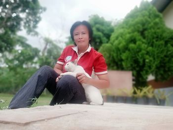 Rear view of boy sitting outdoors