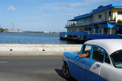 American car on sea against sky