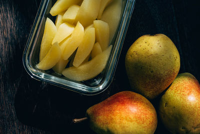 High angle view of sliced pears in container on table