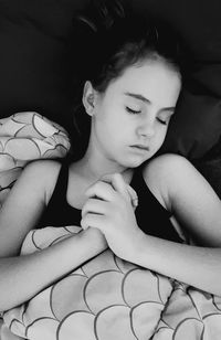 Close-up of baby sleeping on bed at home