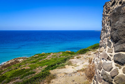 Scenic view of sea against clear blue sky