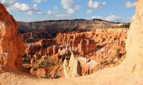 Panoramic view of rock formations against cloudy sky