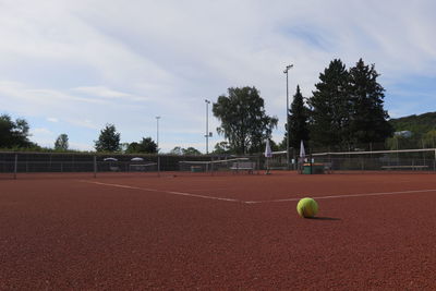 Tennis ball on court against sky