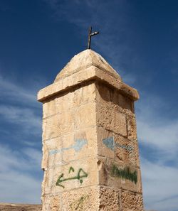 Low angle view of bell tower against sky