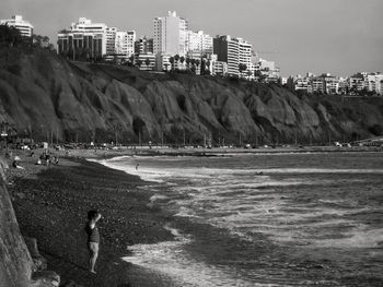 Panoramic view of beach and buildings against sky