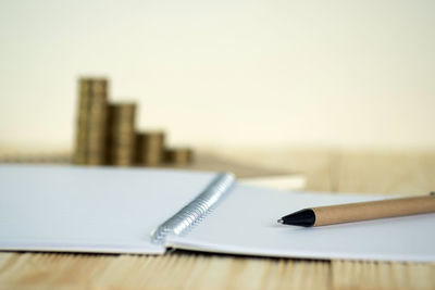 Close-up of pen on table against white background