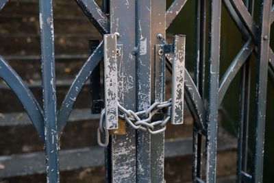 Close-up of lock on metal fence 