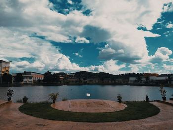 View of buildings in city against cloudy sky