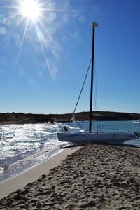 Boat at beach on sunny day