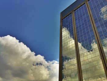 Low angle view of modern building against blue sky