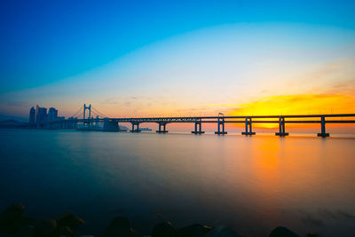 Silhouette of suspension bridge at sunset