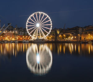 Illuminated ferris wheel at night