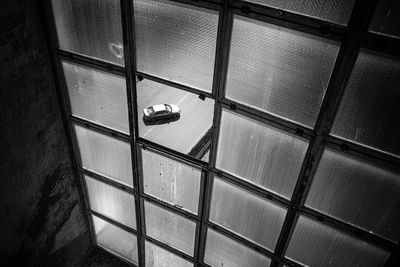 High angle view of car on road seen through window