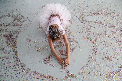 High angle view of girl dancing on confetti