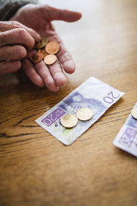 Hands holding banknotes and coins