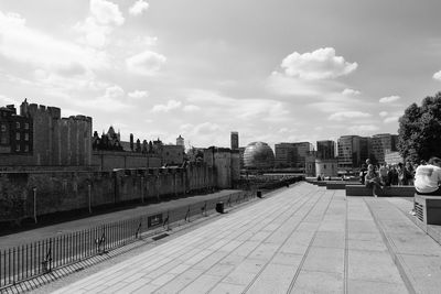 View of cityscape against cloudy sky