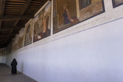 Nun walking inside the sanctuary of la verna in tuscany