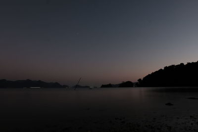 Scenic view of sea against clear sky at sunset